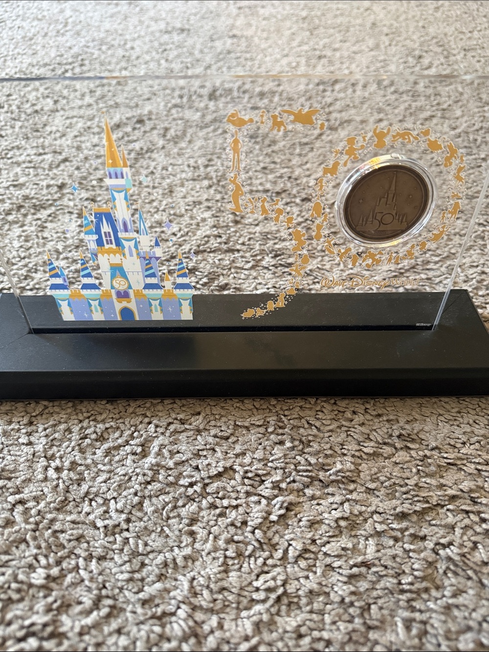 Walt Disney World 50th Anniversary commemorative coin and Cinderella Castle